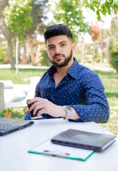 Academy handsome male freelancer looking camera while working laptop outdoors Small