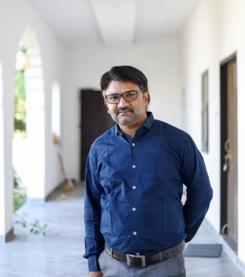 Academy portrait middle aged indian male with eyeglasses wearing blue shirt Small